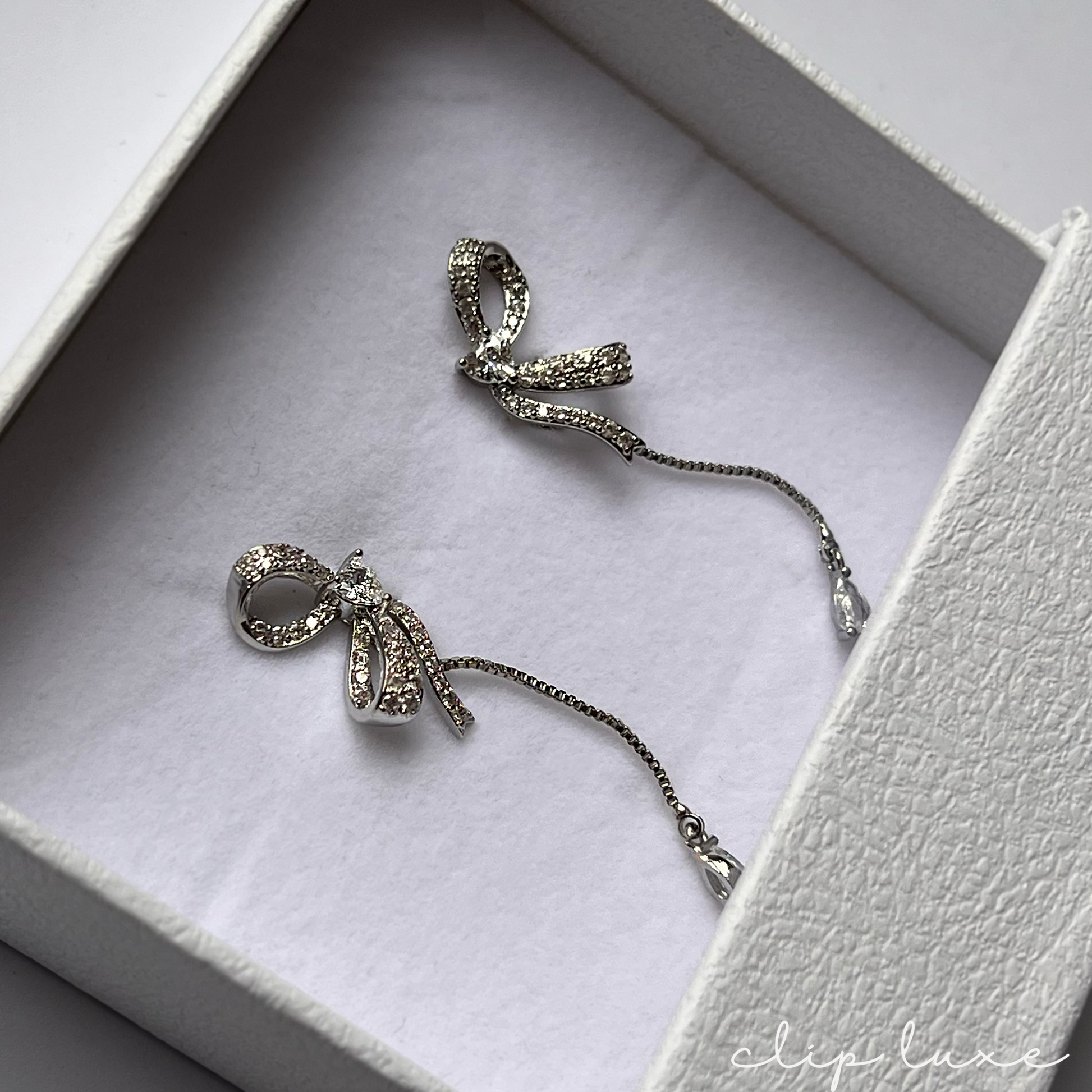 Petite silver half bow clip on earrings