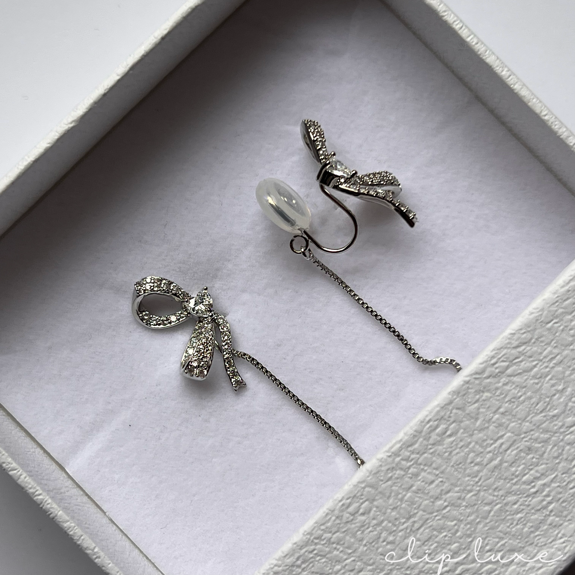 Petite silver half bow clip on earrings