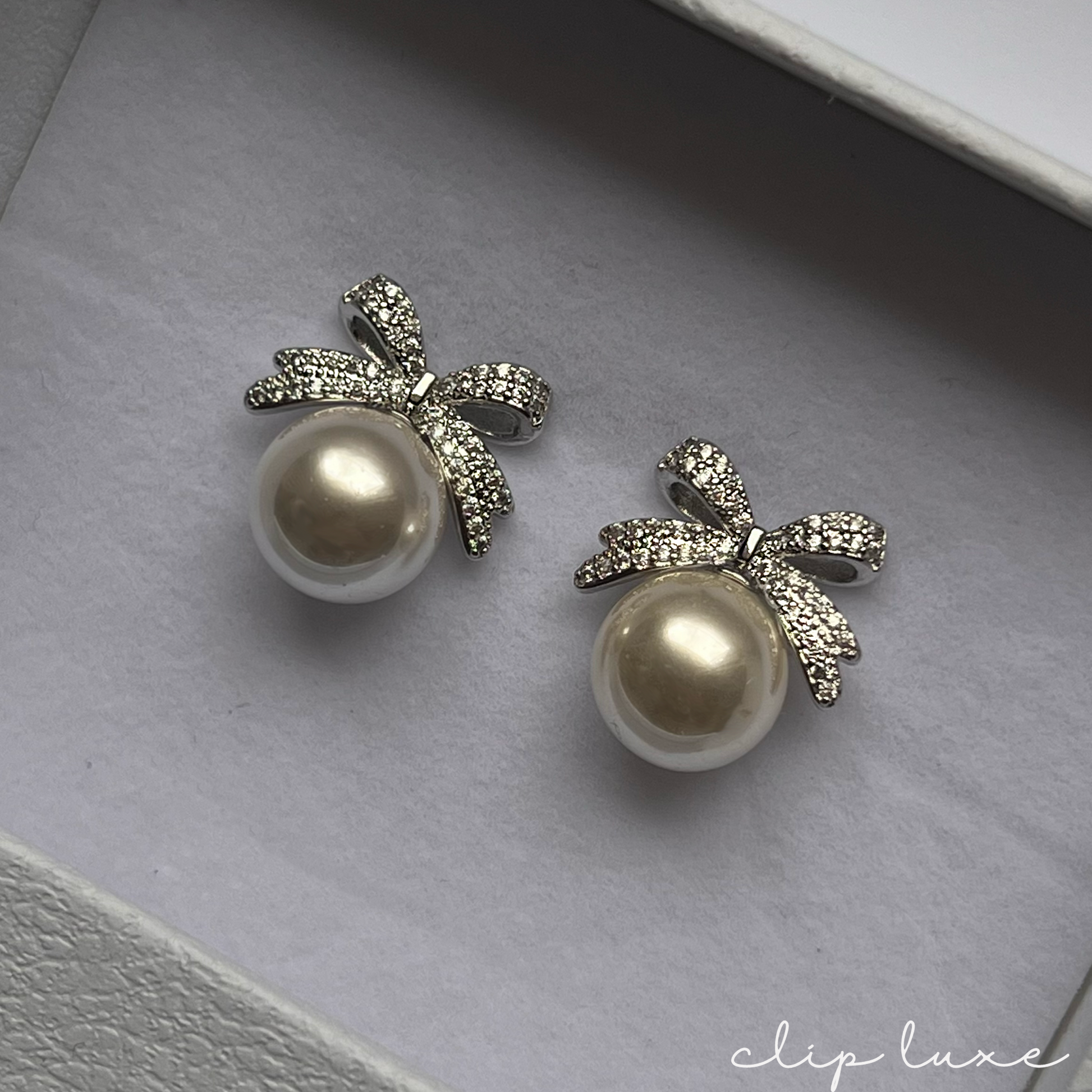 Luxe silver bow pearl clip on earrings