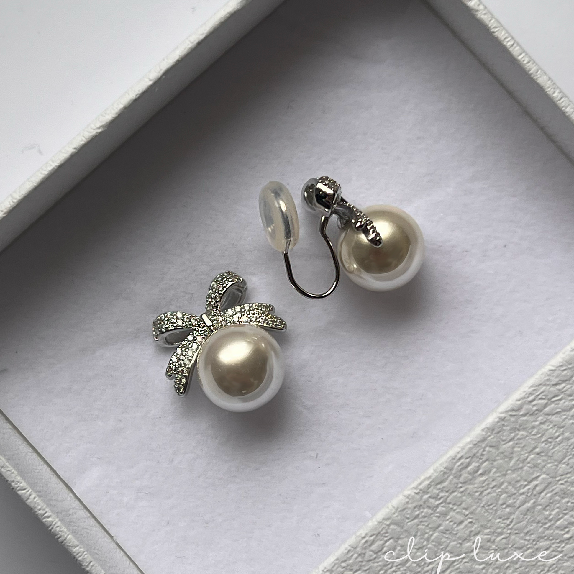 Luxe silver bow pearl clip on earrings